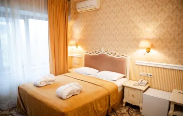 A cozy standard room interior at the Royal Olympic Hotel in Kyiv