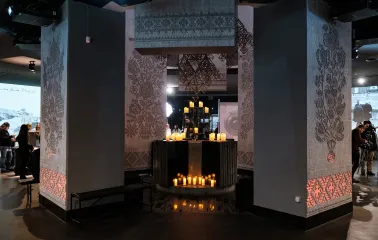 Hall of Memory in the Holodomor museum with candles and traditional ornaments