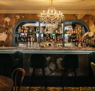 Etre Sofie - elegant, long bar counter featuring a prominent liquor display