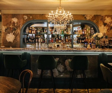 Etre Sofie - elegant, long bar counter featuring a prominent liquor display