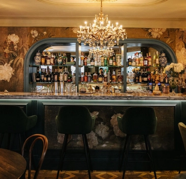 Etre Sofie - elegant, long bar counter featuring a prominent liquor display