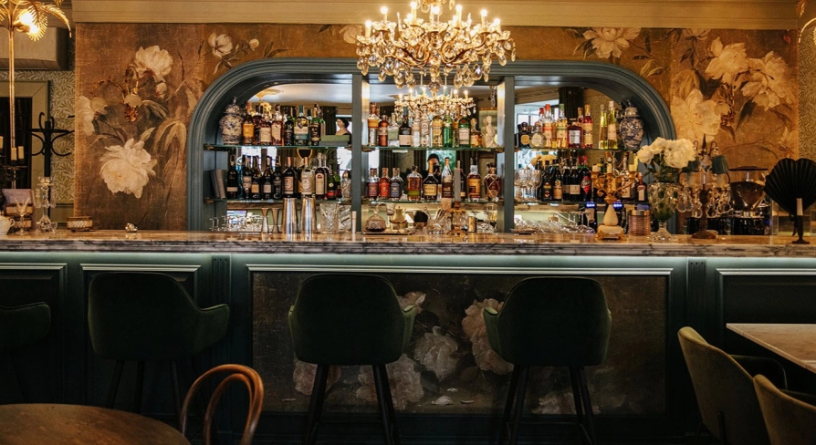 Etre Sofie - elegant, long bar counter featuring a prominent liquor display