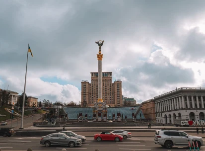 Independence Monument in Kyiv - wide view of the Independence Monument and city traffic