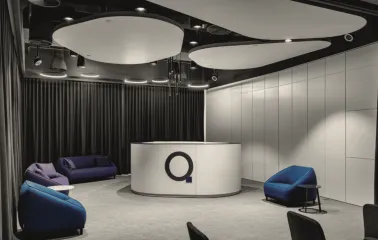 IQ Business Center in Kyiv - lounge area with white desk, logo and soft seats