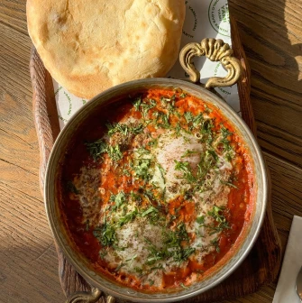 Shakshuka with greens and pita at Shalom restaurant