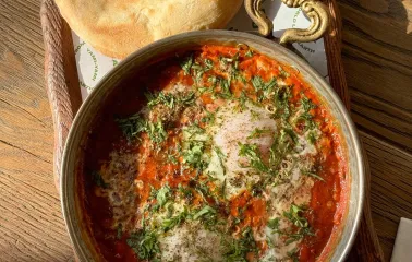 Shakshuka with greens and pita at Shalom restaurant