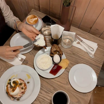 Spelta – cozy breakfast with coffee, bread, cheese and boiled egg on wooden table