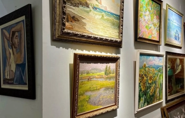 Paintings of different genres on the wall in L'Art Gallery in Kyiv