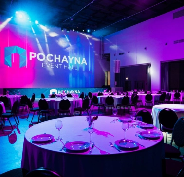 Hall for a gala dinner at Pochayna Event Hall in Kyiv with served tables