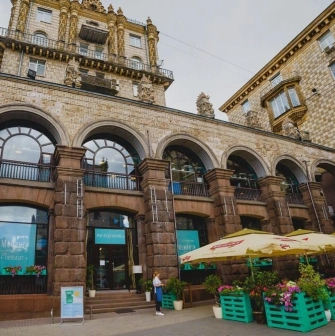 Restaurant Momenty - historic stone facade with arched windows and outdoor terrace