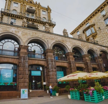 Restaurant Momenty - historic stone facade with arched windows and outdoor terrace