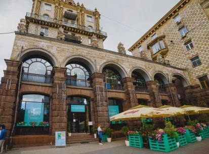 Restaurant Momenty - historic stone facade with arched windows and outdoor terrace