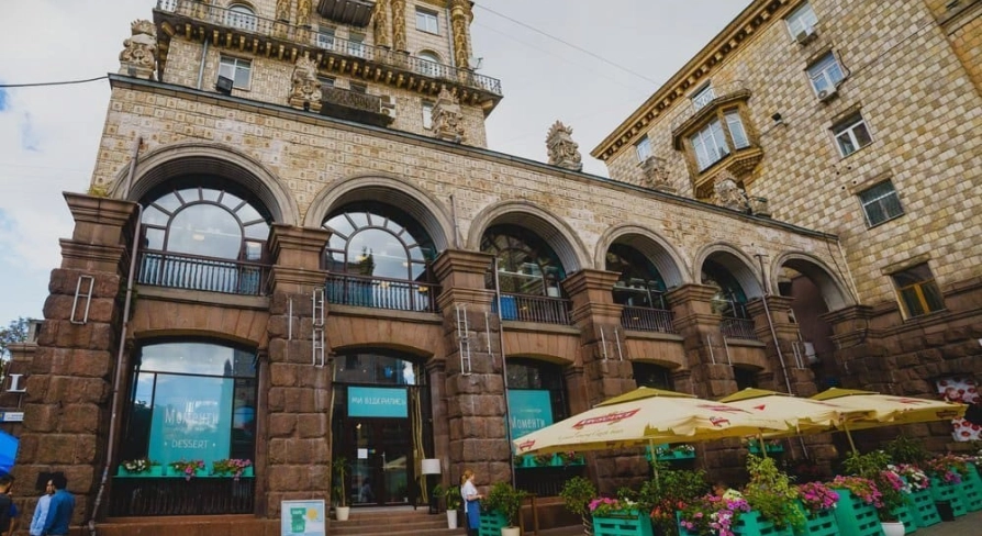 Restaurant Momenty - historic stone facade with arched windows and outdoor terrace