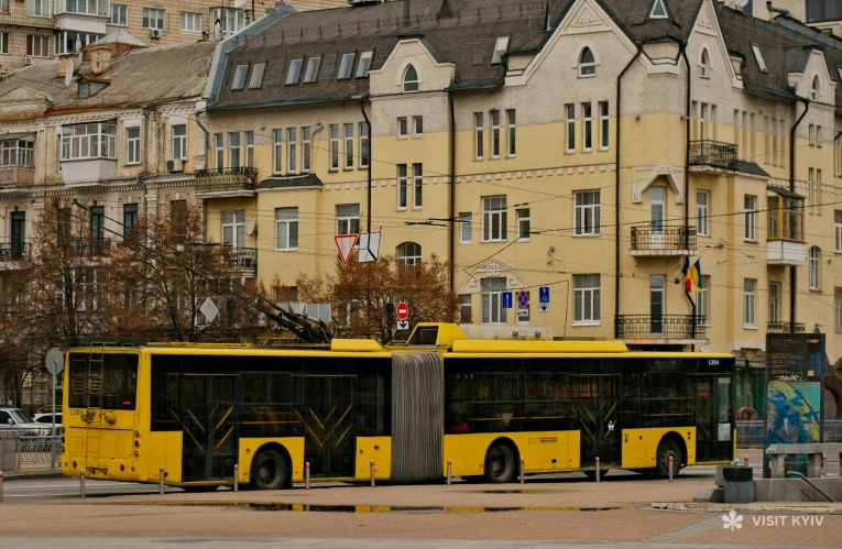 Yellow trolleybus driving in Kyiv city center