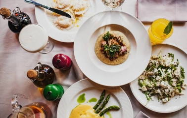 Resraurant Under Wonder - close-up of two artfully plated dishes with gourmet ingredients on a dining table