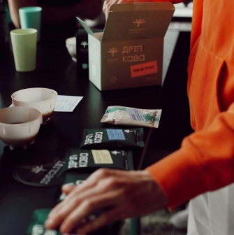 Idealist Coffee - display shelf with branded bags of coffee beans ready for sale