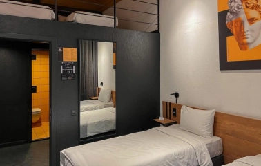 Modern interior of a room at the Globe Runner hostel in Kyiv with two beds and a mezzanine