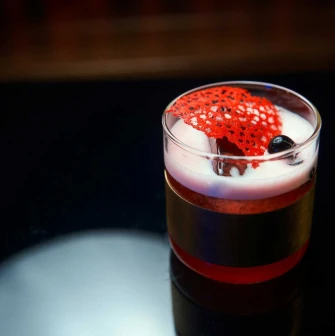Signature cocktail with garnish served on a table at Pink Freud bar
