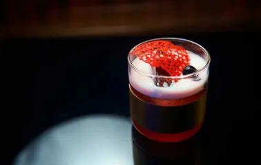 Signature cocktail with garnish served on a table at Pink Freud bar