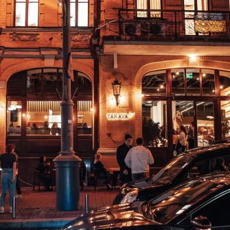 Takava in Kyiv - evening view of brick cafe facade with arched windows and lights