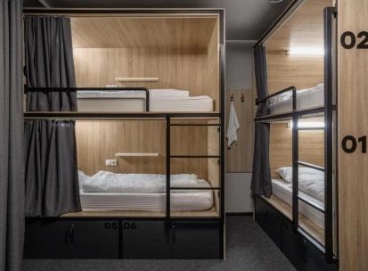 Bunk beds with lighting and curtains at Kyiv Hostel in Kyiv