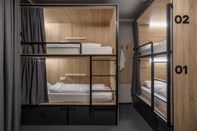 Bunk beds with lighting and curtains at Kyiv Hostel in Kyiv