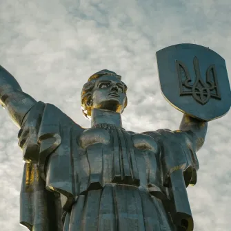 Motherland - majestic steel statue raising a sword and shield with a trident to the sky