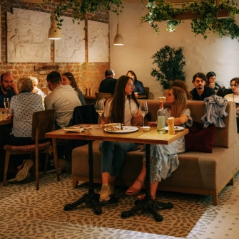 Restaurant Tisto, Syr i Titka Bella - indoor dining area with brick walls and stucco reliefs