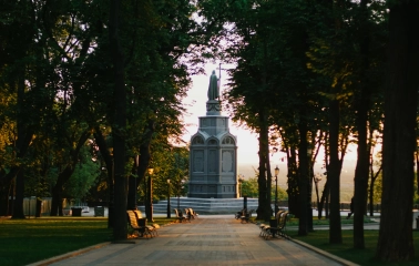Monument to Vladimir the Great - view of the statue standing at the end of a shady tree-lined park alley