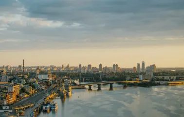 Dnipro river - sunset view of Havanskyi Bridge and Podil embankment skyline
