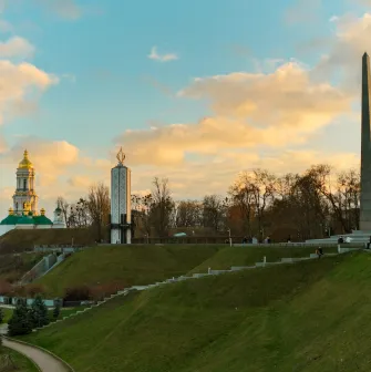 Park of Eternal Glory in Kyiv - sunset landscape with the Obelisk, Holodomor Memorial, and Lavra domes