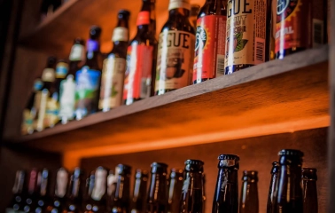 Pab Kedy - shelves lined with rows of bottled beer in a pub setting