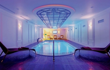 Fairmont Grand - luxurious indoor swimming pool and spa area with warm lighting