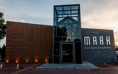 Mayak - modern restaurant facade with glass entrance and wooden panels