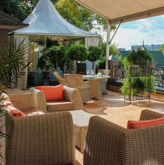 Restaurant Terasa - sunny rooftop lounge with wicker furniture and a small white tent