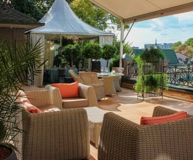 Restaurant Terasa - sunny rooftop lounge with wicker furniture and a small white tent