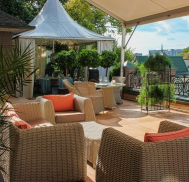 Restaurant Terasa - sunny rooftop lounge with wicker furniture and a small white tent