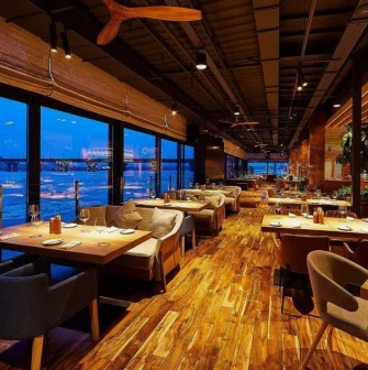 Restaurant Veranda on the river - elegant dining area with large windows overlooking the Dnipro river