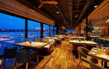 Restaurant Veranda on the river - elegant dining area with large windows overlooking the Dnipro river