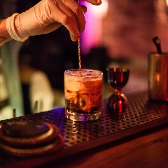 A bartender preparing a cocktail at the "Hvlv" bar in Podil, Kyiv