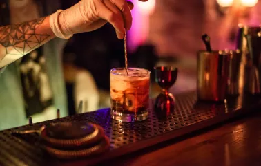 A bartender preparing a cocktail at the "Hvlv" bar in Podil, Kyiv