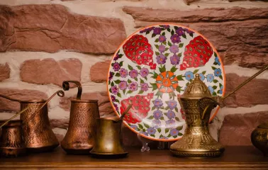 Sofra in Kyiv - decor composition with copper coffee pots and painted ceramic plate