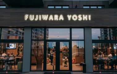 Facade of Fujiwara Yoshi restaurant in Kyiv with an illuminated sign