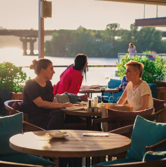 Mayak - spacious dining area offering a picturesque river view through windows