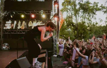 Vyava in Kyiv - singer in black leaning into a microphone in front of a crowd