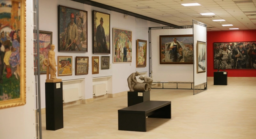 Muzei Suchasnoho Mystetstva in Kyiv - spacious and well-lit main gallery corridor filled with diverse paintings and small sculptures on pedestals