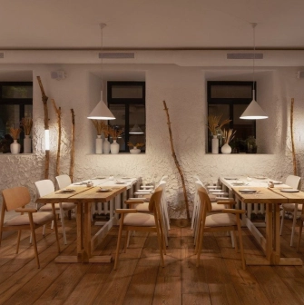 Restaurant 100 Rokiv Tomu Vpered - cozy tables near white textured walls and dark windows