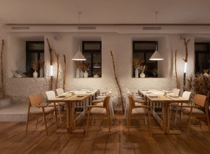 Restaurant 100 Rokiv Tomu Vpered - cozy tables near white textured walls and dark windows
