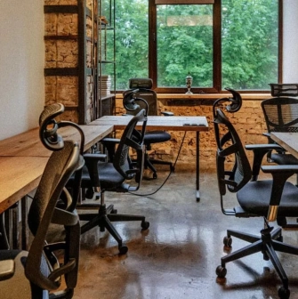 Coworking space with wooden tables and office chairs at Generator in Kyiv