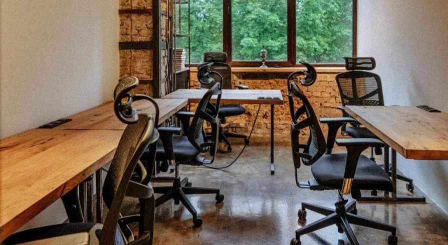 Coworking space with wooden tables and office chairs at Generator in Kyiv